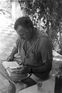 EH 3963 Ernest Hemingway reading outside at Finca Vigia in Cuba. Please credit "Ernest Hemingway Collection/John F. Kennedy Presidential Library and Museum, Boston"